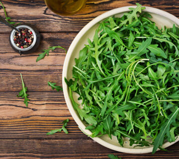 Fresh leaves arugula bowl wooden background flat lay top view 360x320