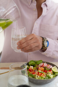 Front view man eating salmon bowl 200x300