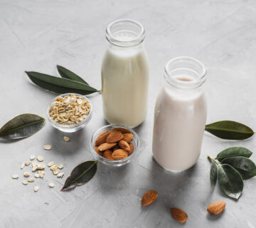 High angle milk bottles with almonds oats 360x320